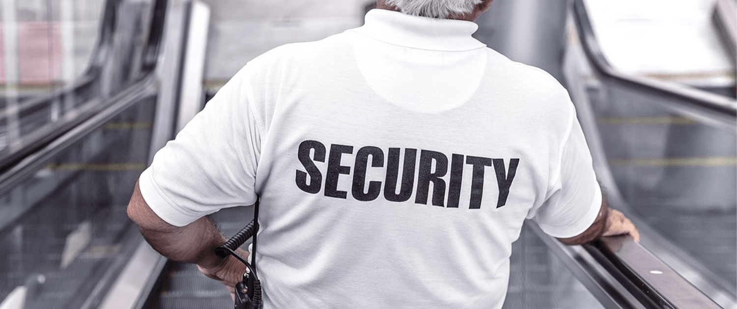 Photo of a back of a person wearing a shirt that says 'Security'