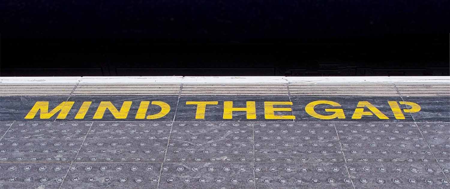 Photo of a station platform showing the words Mind the Gap